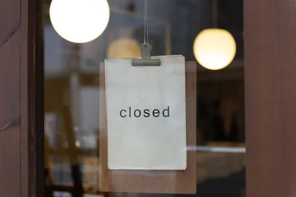 Closed sign hanging in a doorway
