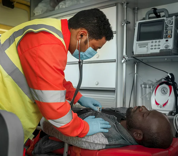 Paramedic treating an injured man in an ambulance